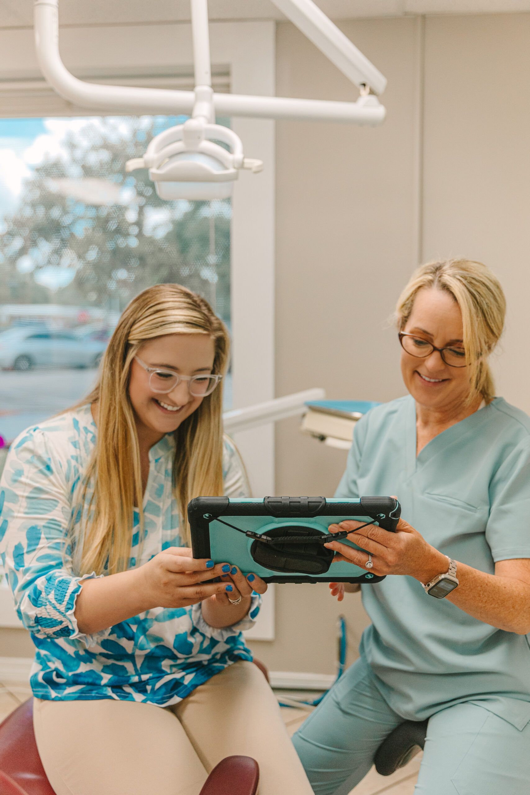 Cedar Pearl Dental patient and staff member viewing digital results on tablet in treatment room