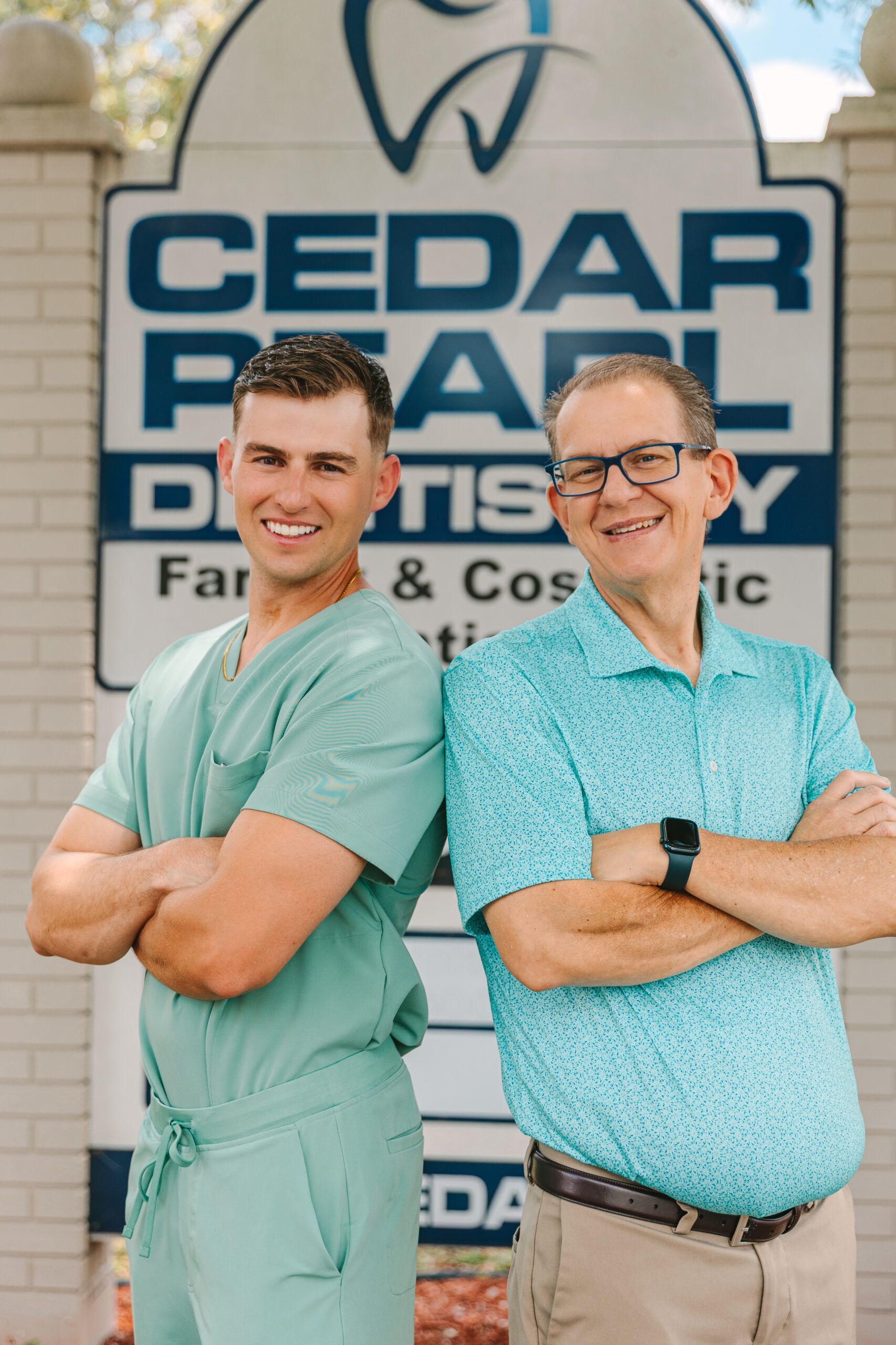 Cedar Pearl Dental team members posing in front of business signage.