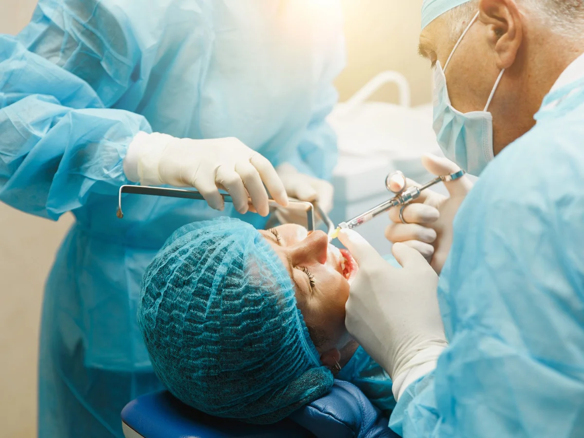 Oral surgeon and assistant performing dental procedure at Cedar Pearl Dental Crestview