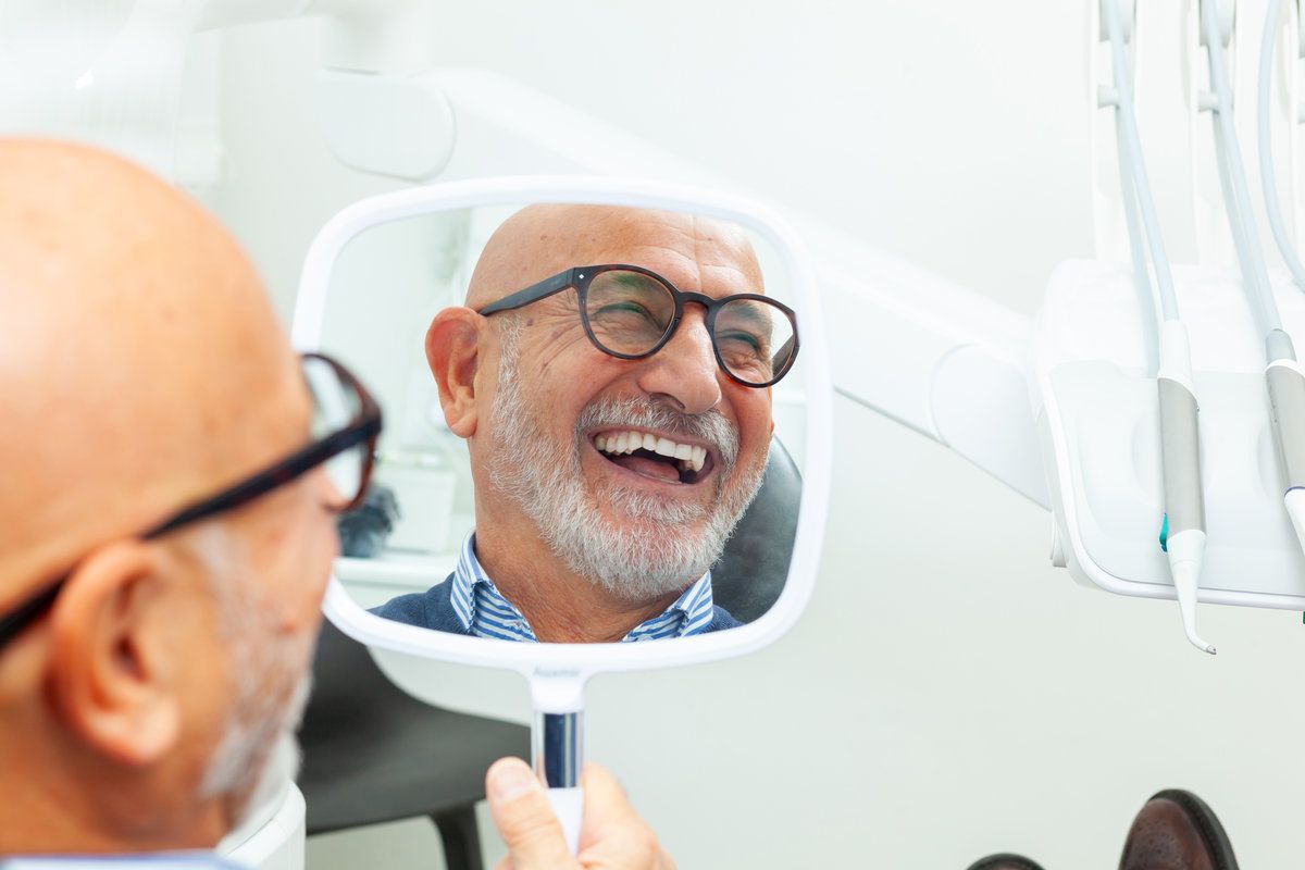 Smiling man looking in mirror