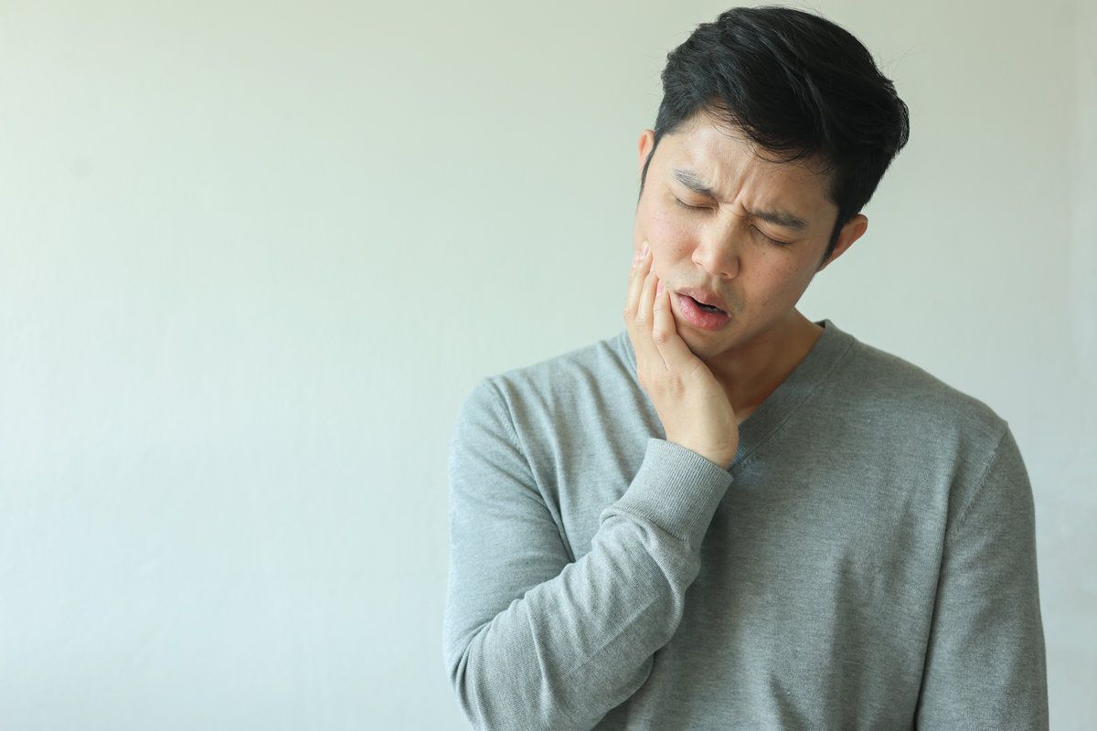 Man experiencing dental pain or discomfort
