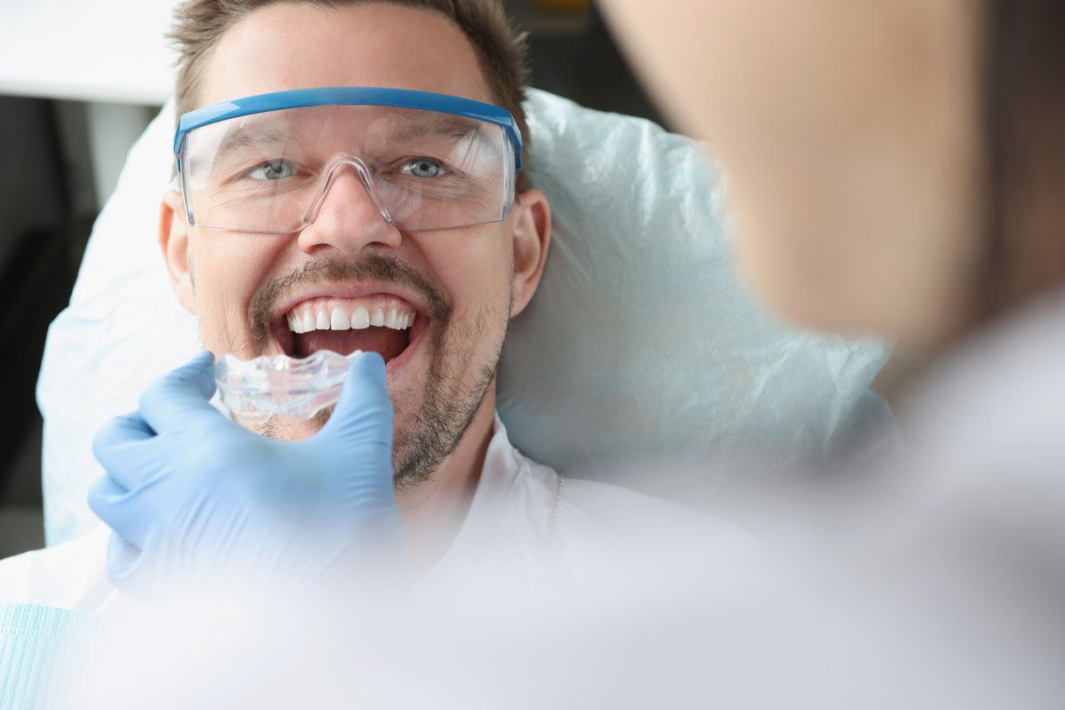 Man in dental chair, smiling