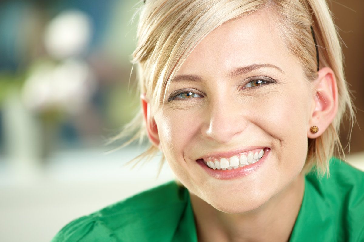 Smiling woman with short blonde hair